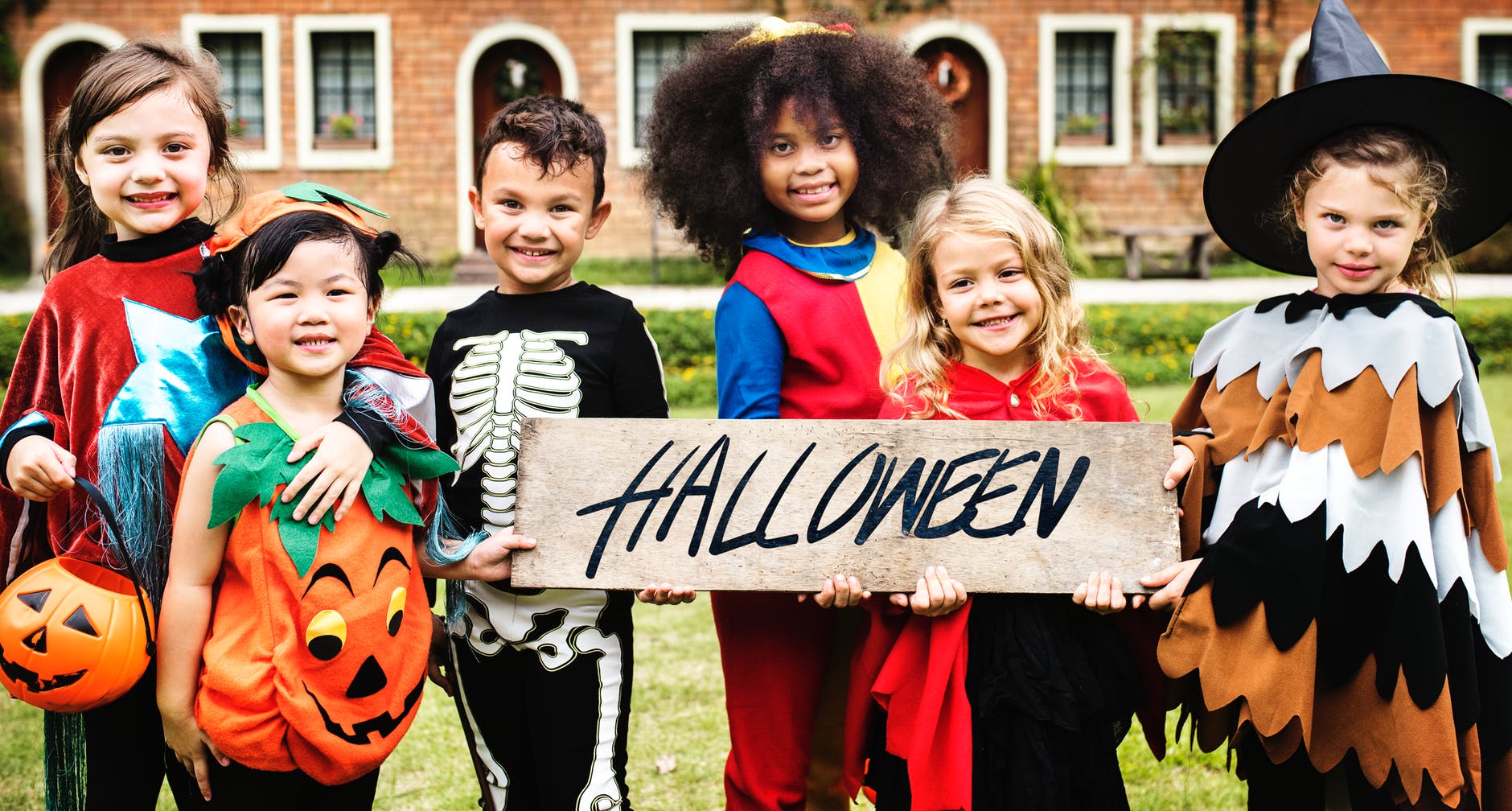 photo of children in halloween costumes smiling