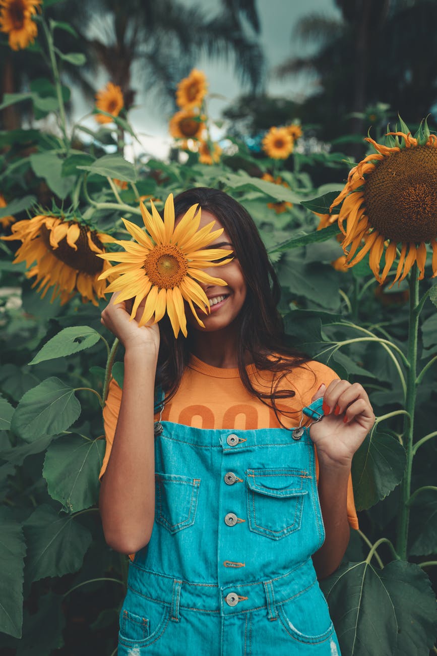 woman holding sunflower