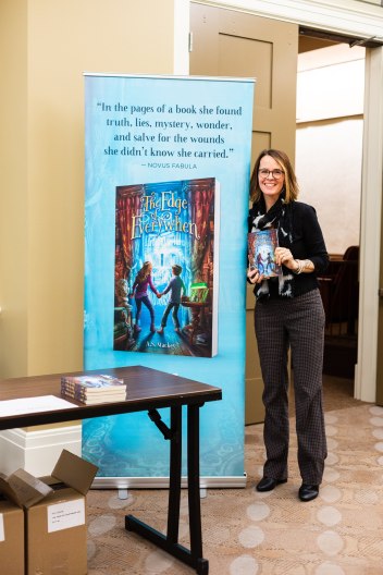 A.S. standing by book display